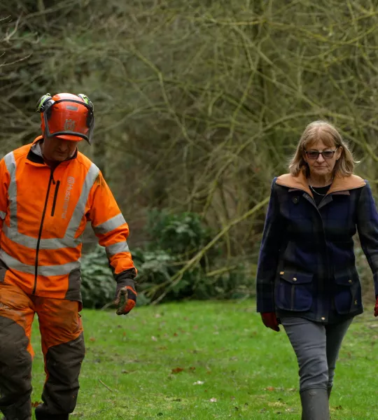 Jane walks her farm with a forestry operative